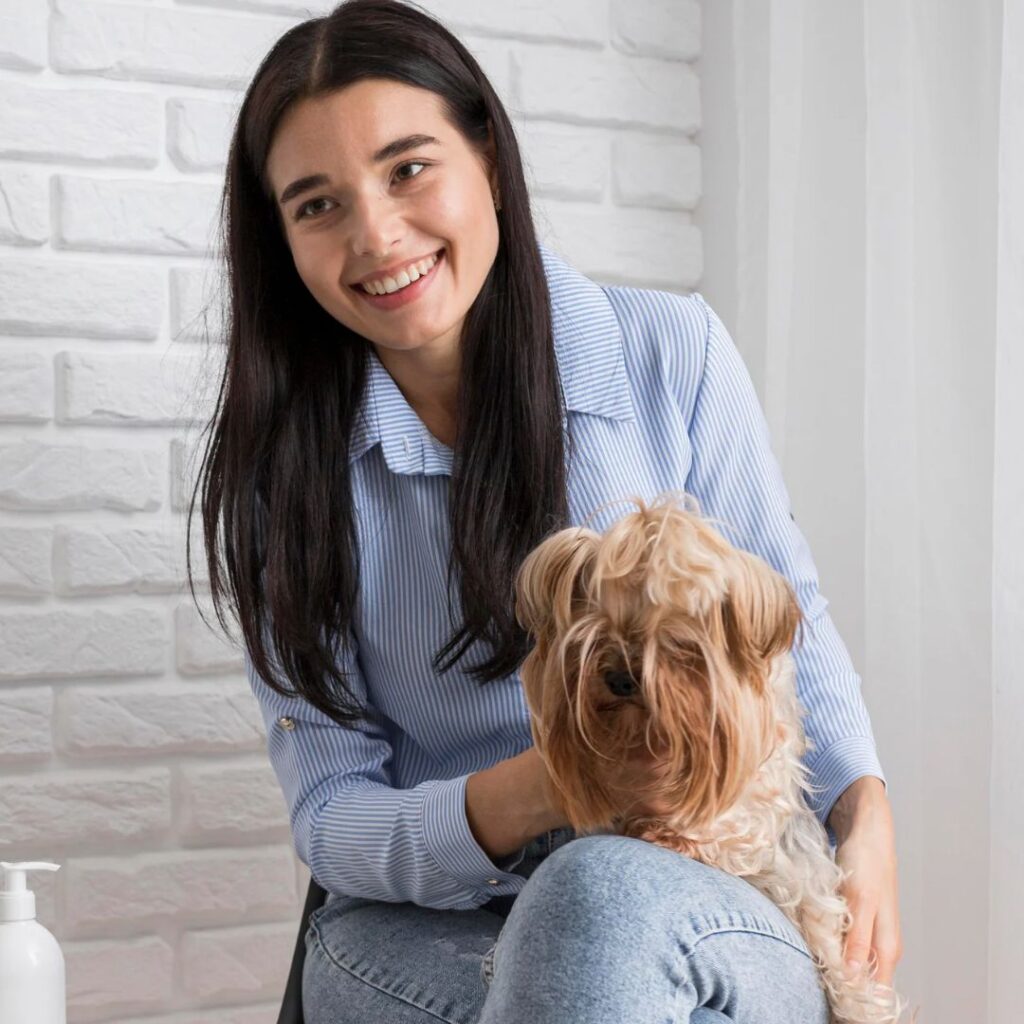 Person sitting with dog on their lap