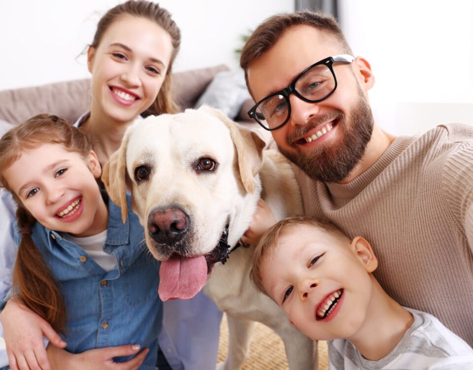 Family taking a selfie with their dog